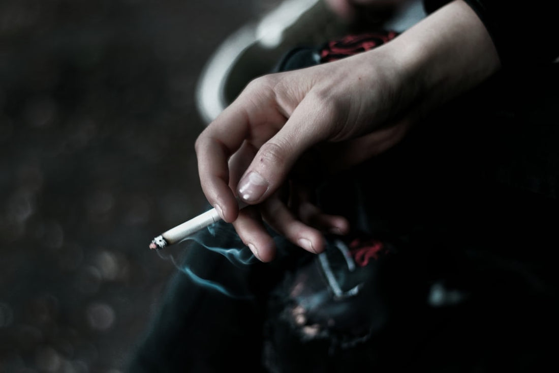 Person holding an unlit cigarette