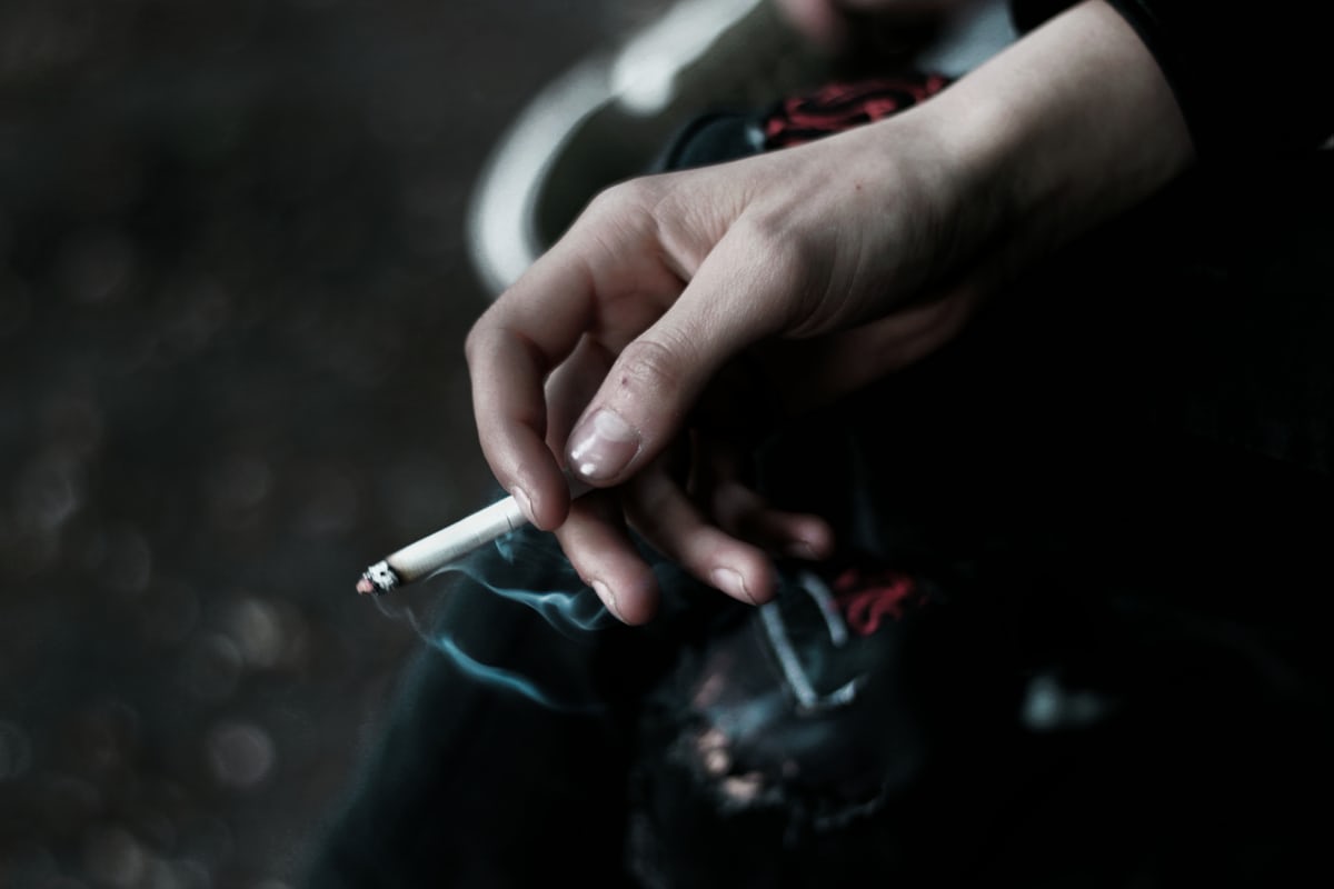 Person holding an unlit cigarette